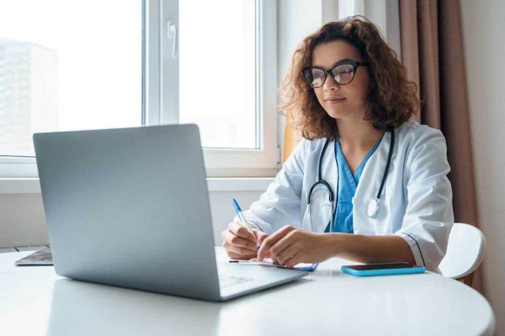 doctor sitting in front of laptop